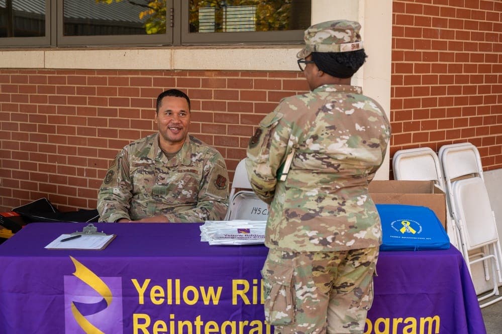 Airmen and family members attend a Yellow Ribbon resource fair with employment, education, and healthcare information booths
