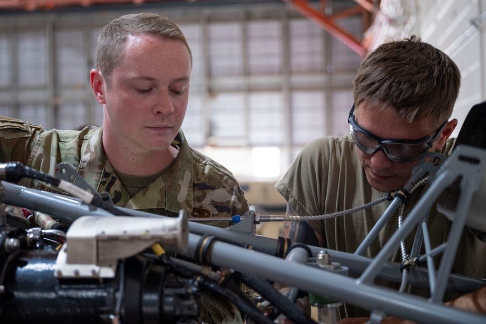 Air Force maintenance crew chief inspecting an aircraft on the flightline