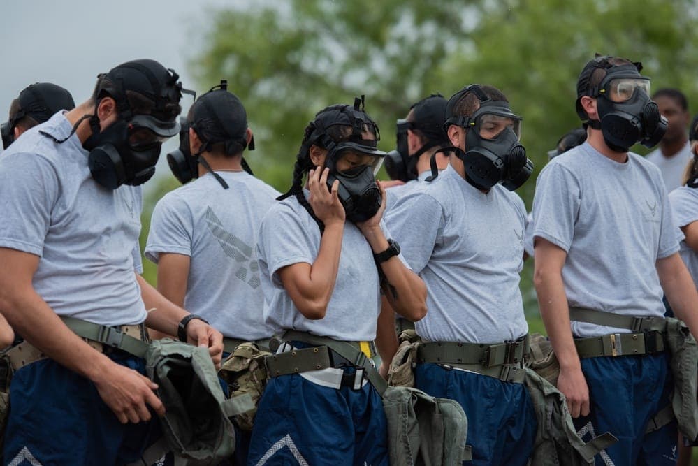 Air Force BMT trainees in MOPP gear during mask confidence training at JBSA-Lackland