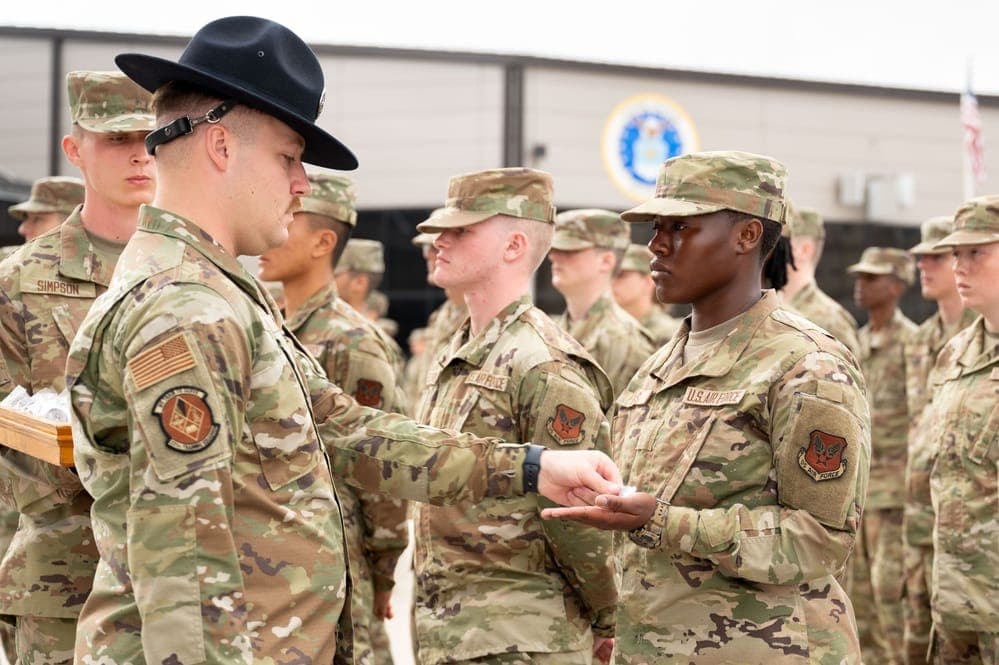 Military Training Instructor presenting the Airman's Coin during a BMT Coin and Retreat Ceremony at JBSA-Lackland