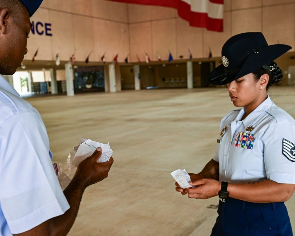 Military Training Instructor collecting an AETC Form 341 from a basic trainee at JBSA-Lackland