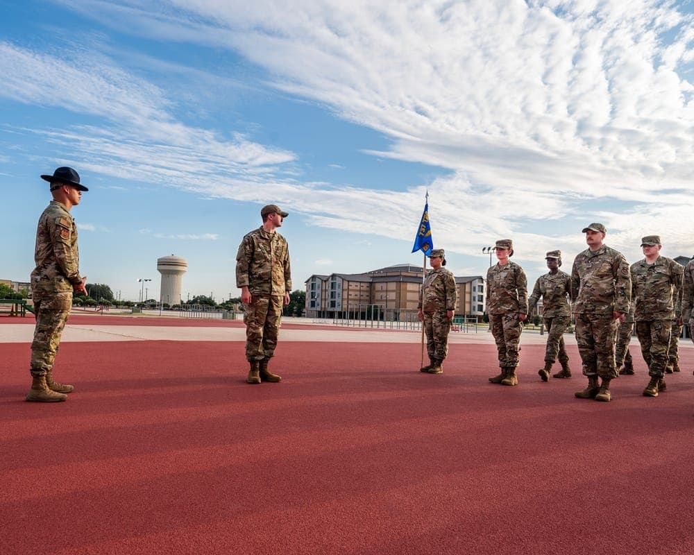 Trainees standing at attention during an open ranks inspection at JBSA-Lackland