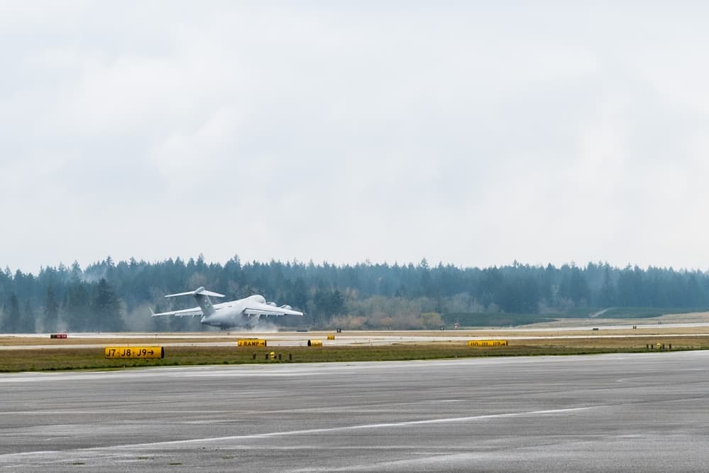 Active duty Air Force Airmen preparing a C-17 aircraft for a training flight