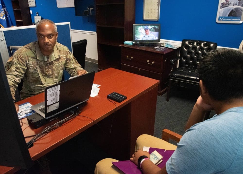 Air Force recruiter reviewing paperwork with a prospective enlistee at a recruiting office
