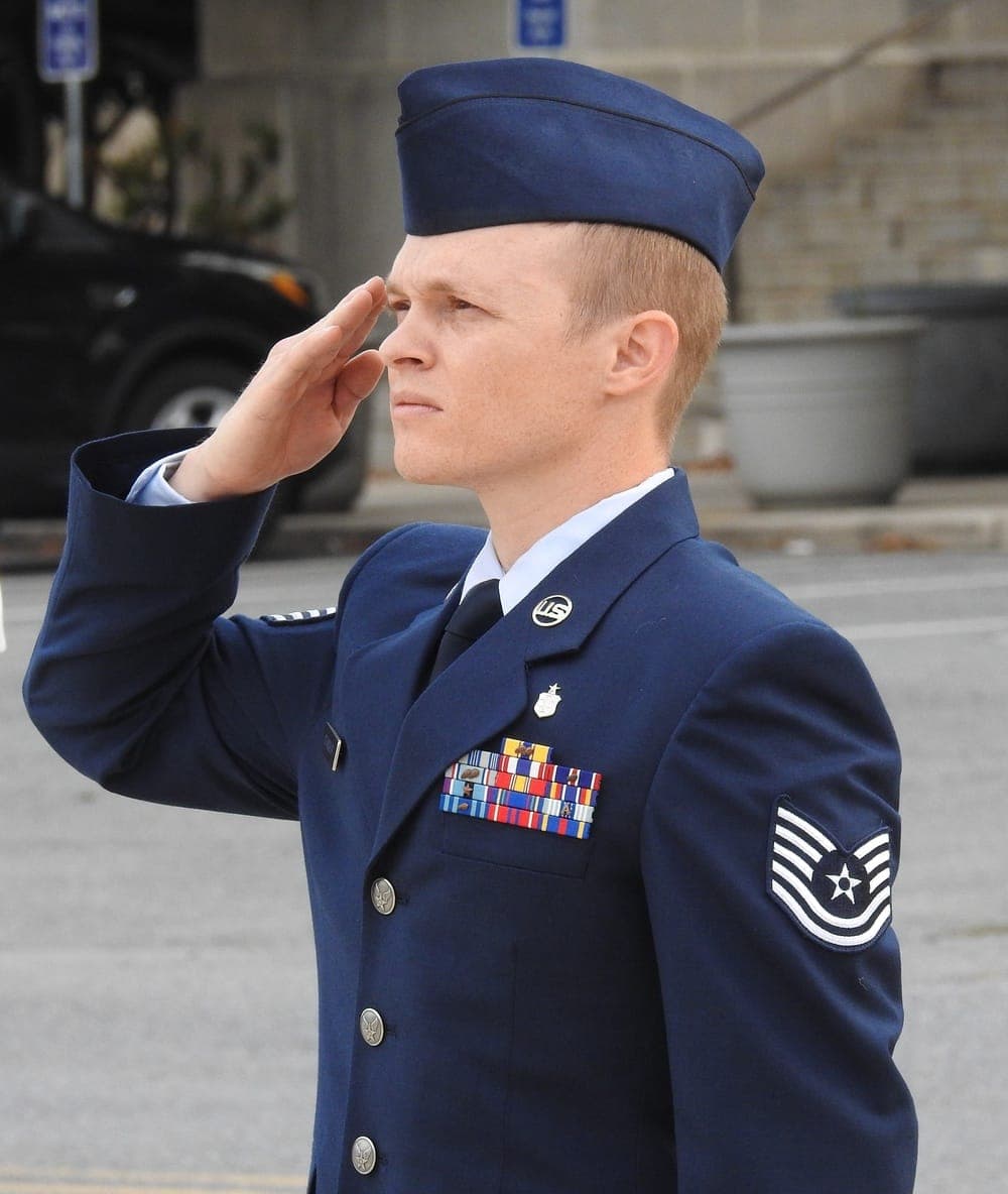 Air Force general saluting during morning reveille ceremony