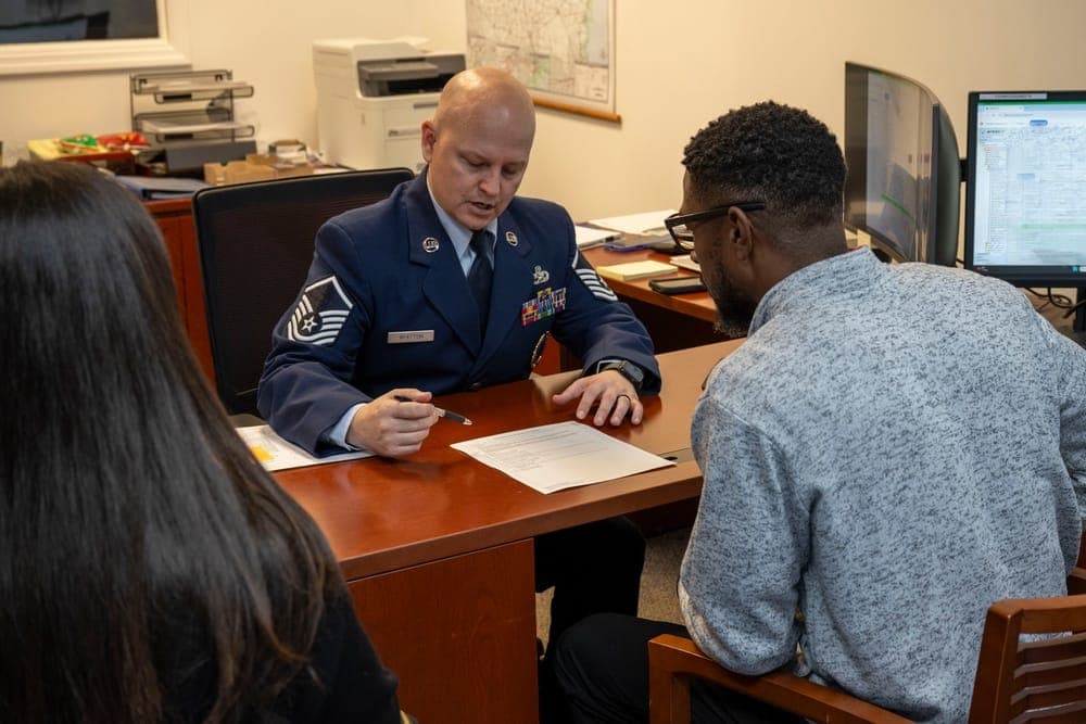 An Air Force recruiter meeting with a prospective enlistee in a recruiting office