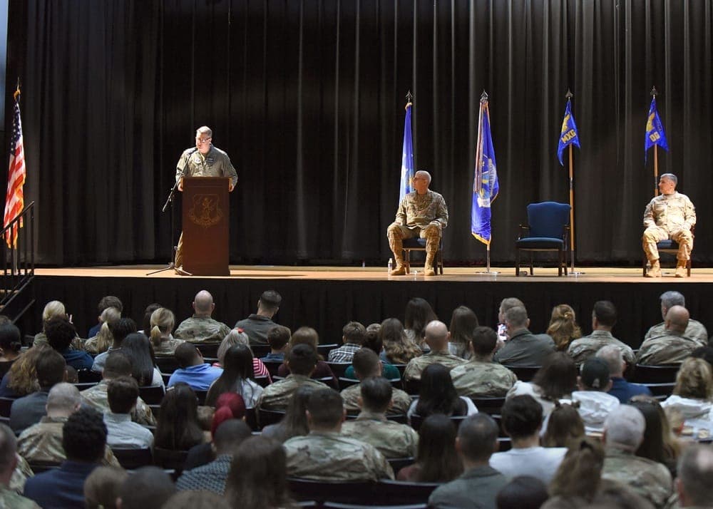 Air Force Airmen saying goodbye to families at a deployment ceremony