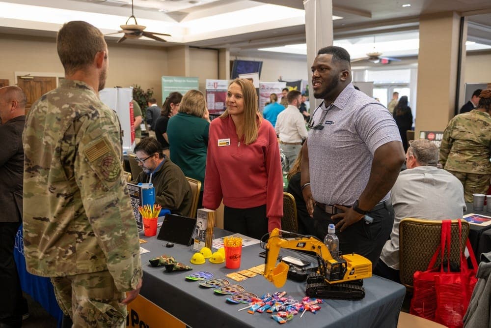 Veterans networking with employers at a military career fair