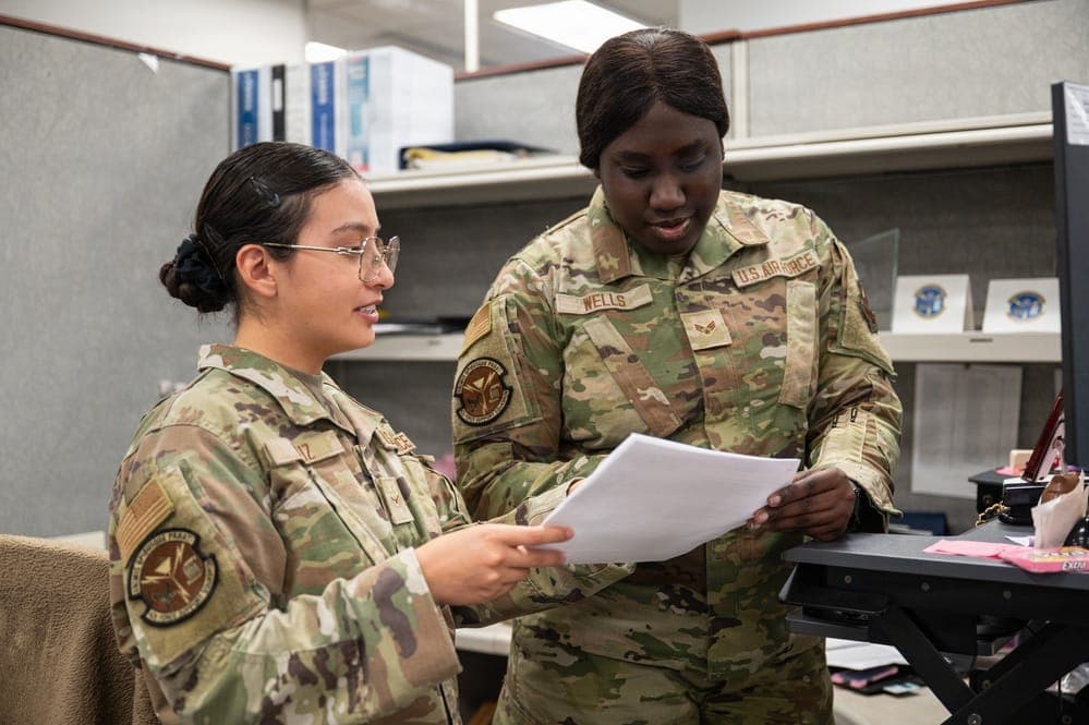 Airman reviewing in-processing paperwork at Military Personnel Flight