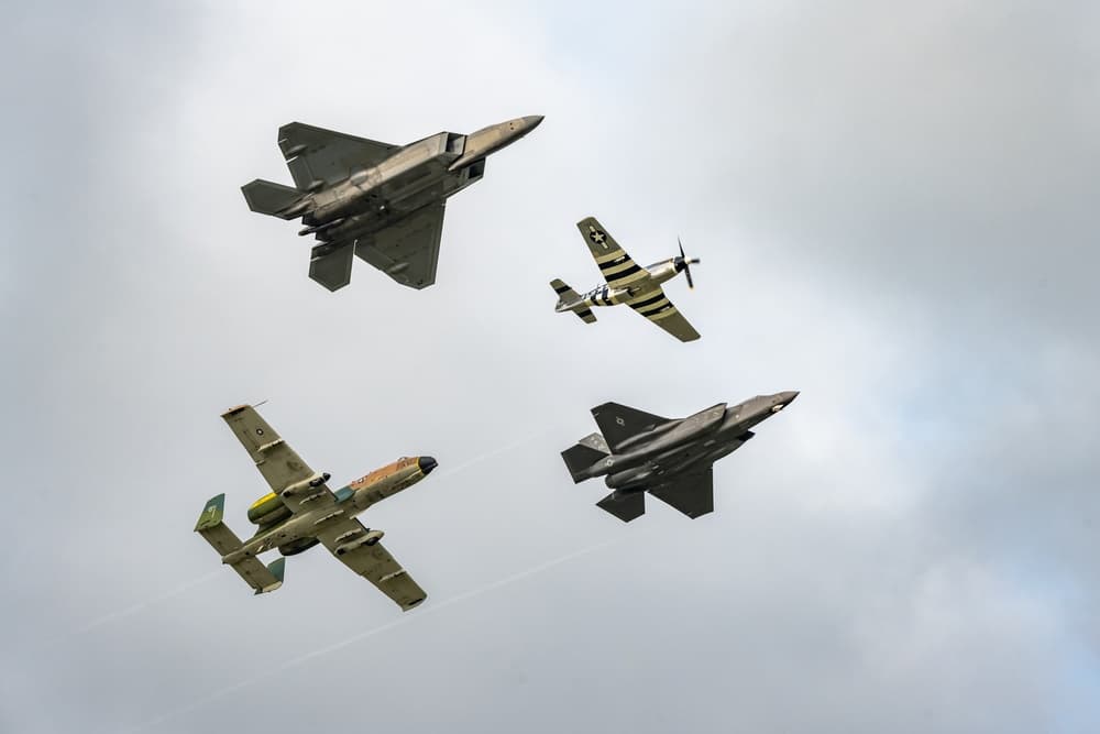 Heritage Flight formation with WWII-era P-51 Mustang flying alongside modern F-22 Raptor and F-35 Lightning II
