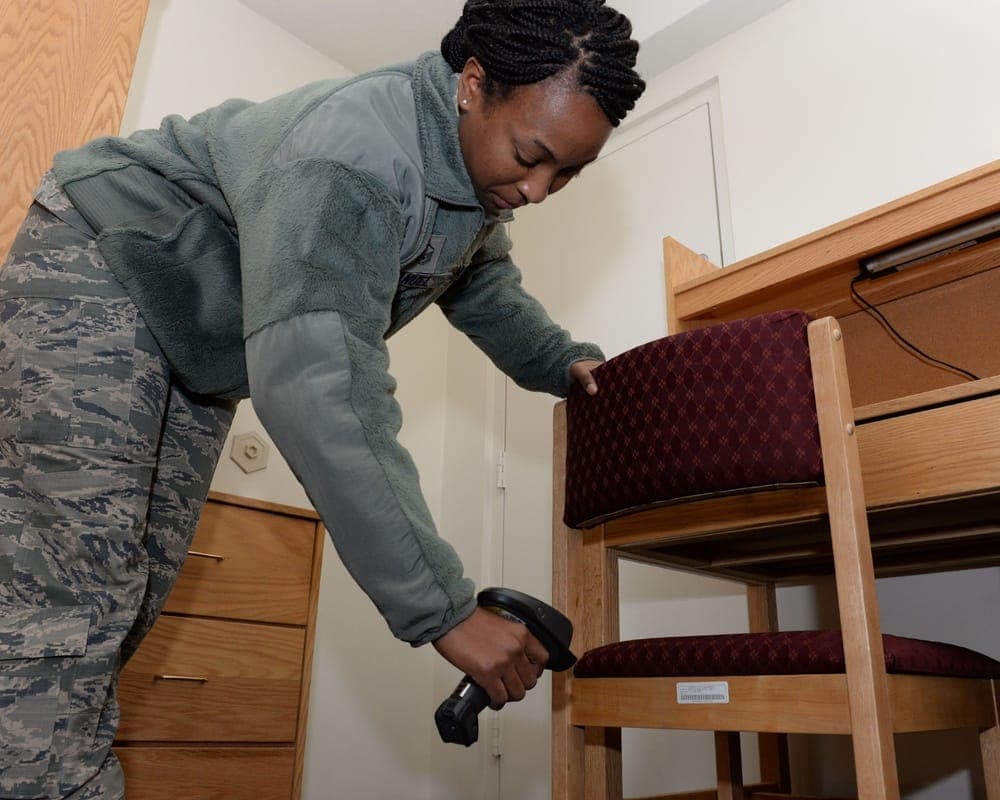 Air Force dormitory room with bed, desk, and furnishings at Wright-Patterson AFB