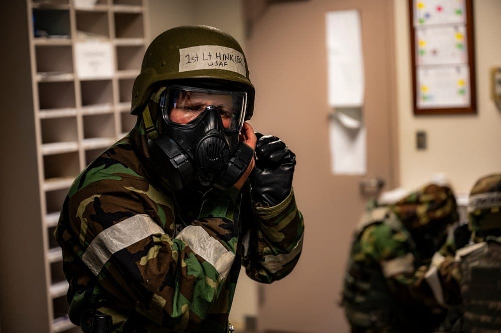 Airman donning MOPP gear during pre-deployment CBRN training