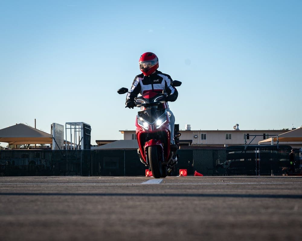 Air Force personnel practicing motorcycle skills on a training range during an MSF course