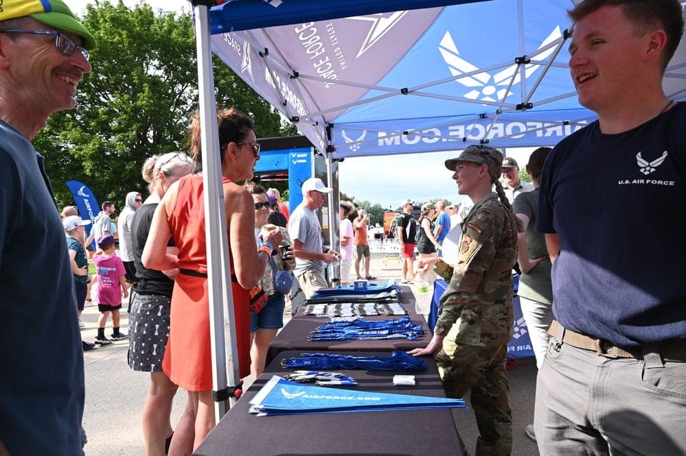 Air Force recruiters at a community outreach event speaking with prospective applicants