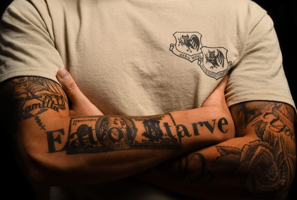 Airman displaying authorized tattoos while in uniform