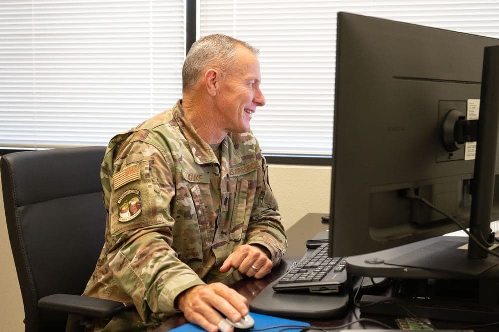 Military member completing security clearance paperwork at a desk
