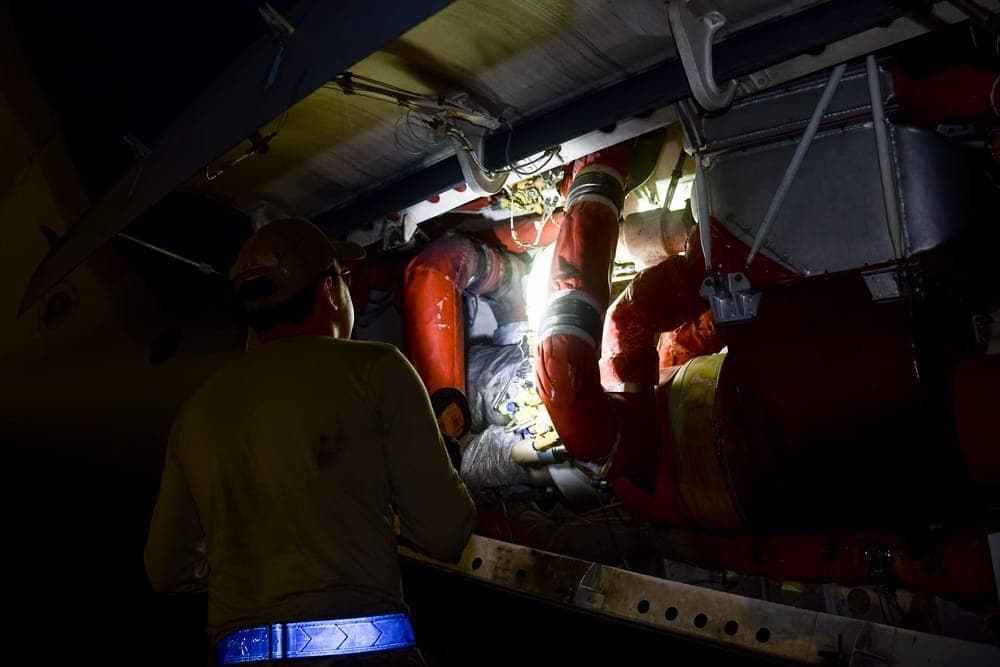 Air Force maintainers working on aircraft during night shift operations