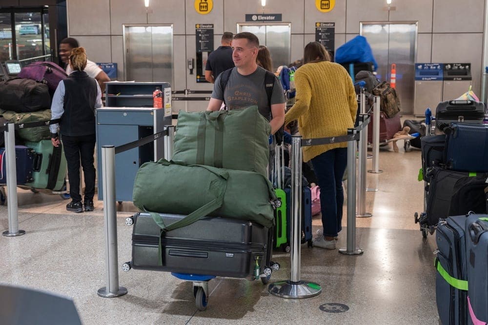 Military passengers checking in at an AMC passenger terminal counter