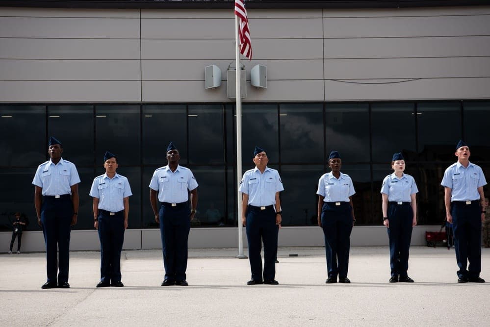 Air Force BMT trainees participate in a naturalization ceremony to become U.S. citizens during Basic Military Training