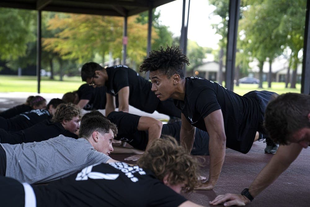 Air Force Special Warfare recruits participating in an Initial Fitness Test at a military track