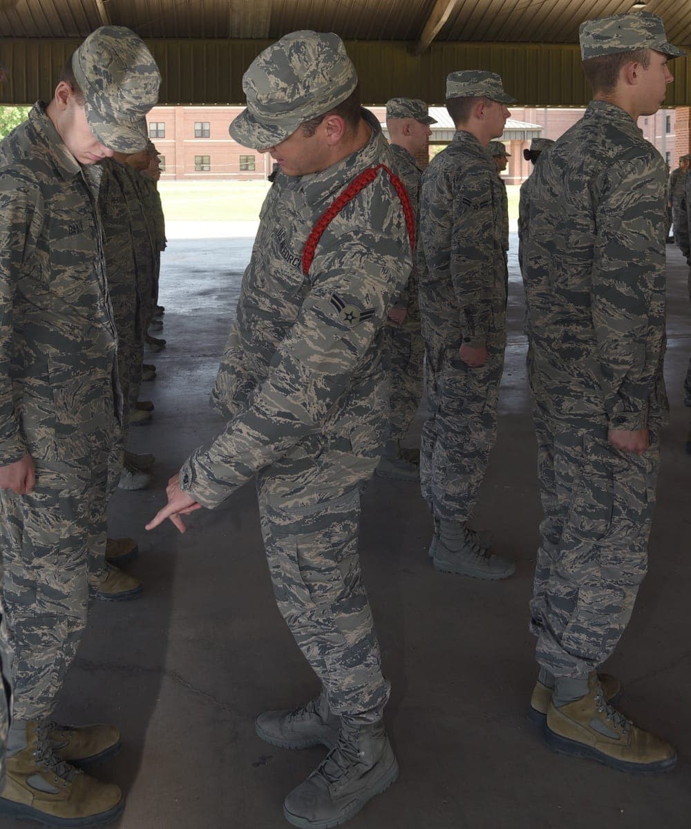 Tech school Airmen wearing colored aiguillettes during formation