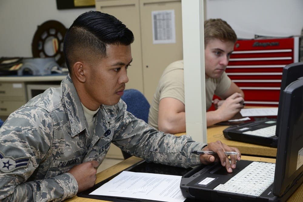 Airmen working on progress check exams during technical training