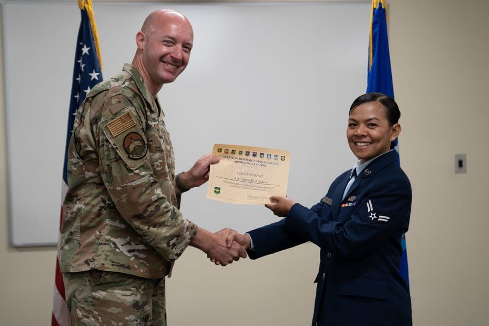 Airmen celebrating at a technical school graduation ceremony